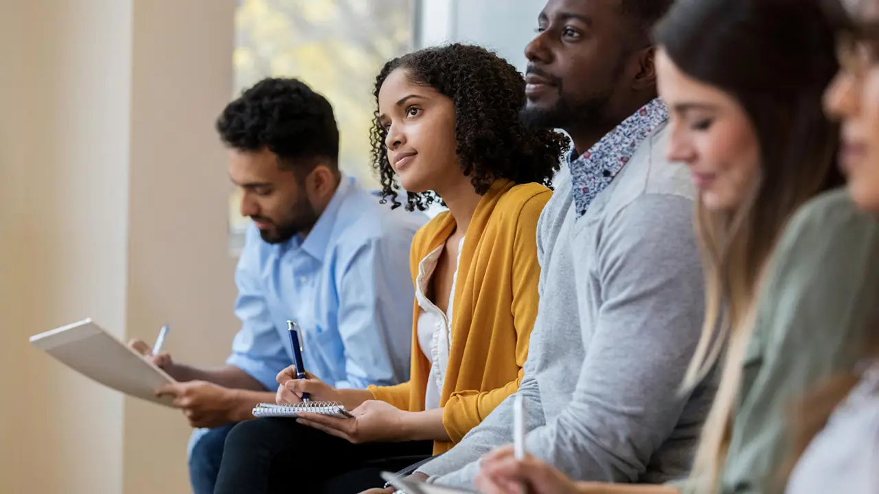 Group of business people sit in a row in a training class