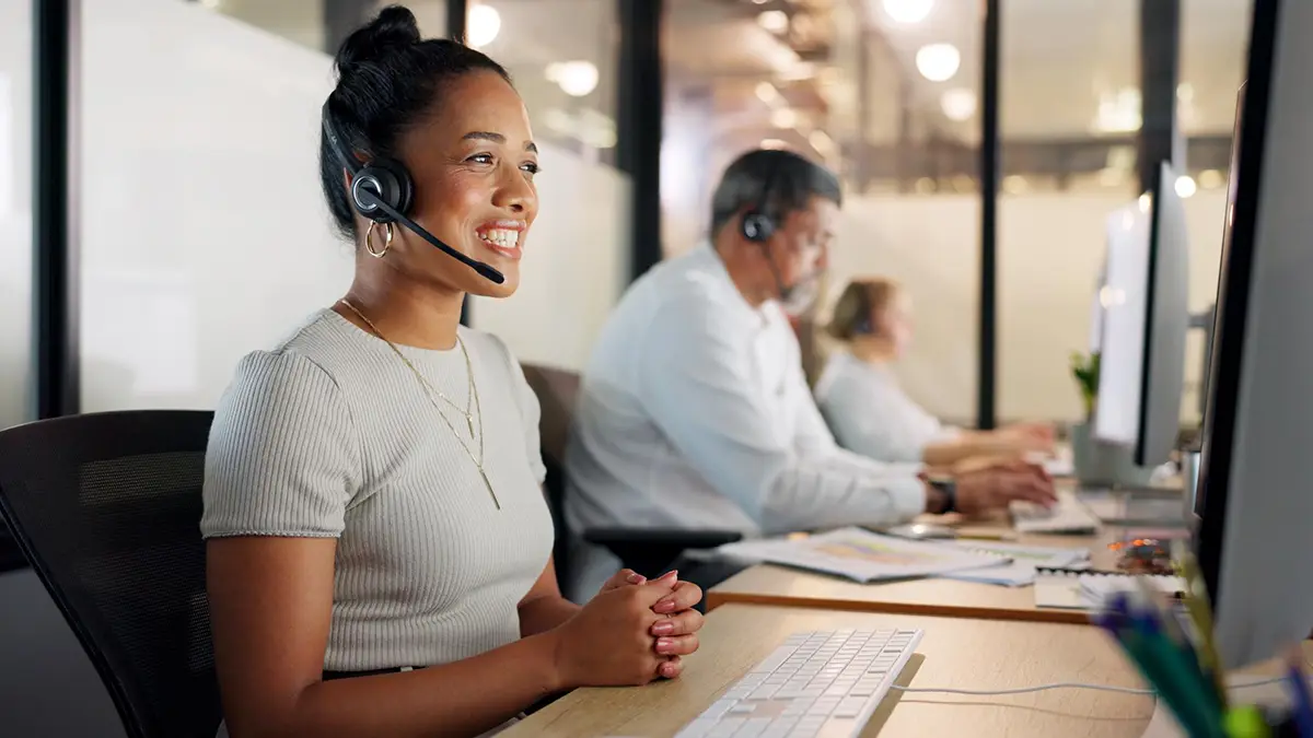 Woman in customer service with headset and smile on face