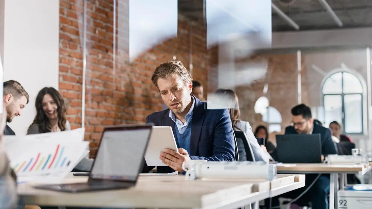 Man working on digital tablet in office environment