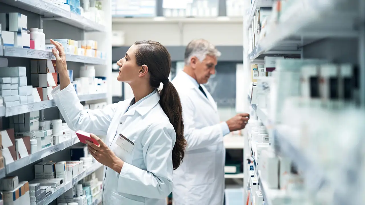 Two pharmacists checking products while working together in a dispensary